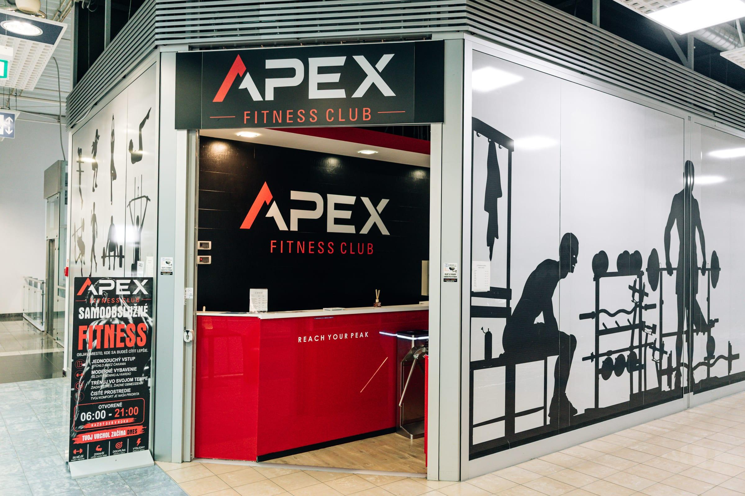 APEX entrance with a red reception desk and a Self-service fitness sign